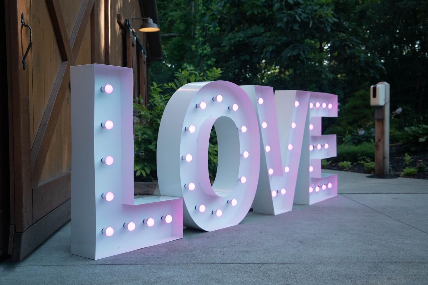 Large LOVE marquee letters with warm bulbs outdoors