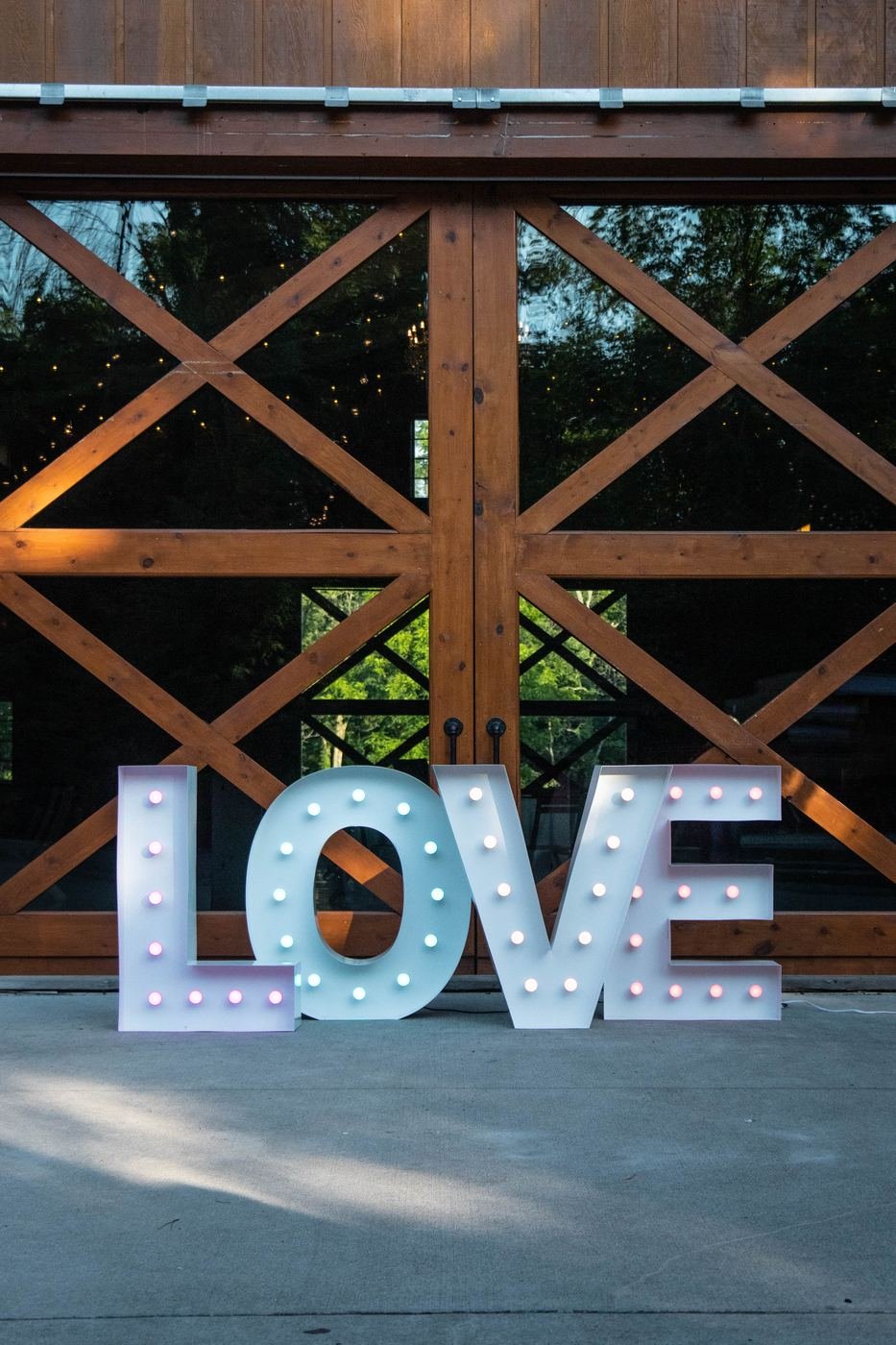 Large LOVE marquee letters lit up for a wedding reception