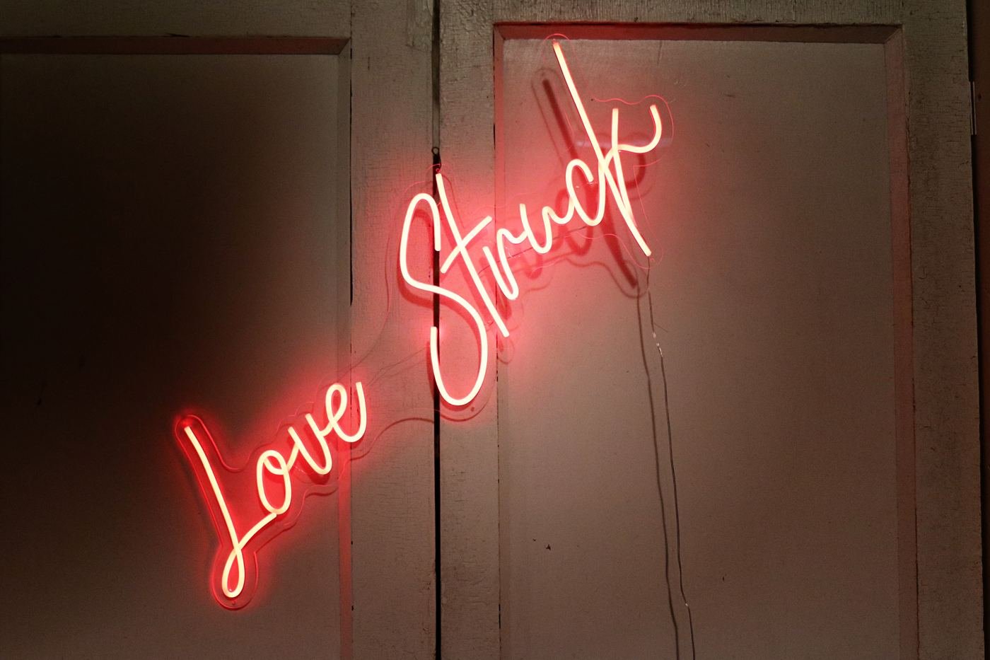 Love Struck neon sign glowing red, available for wedding rental
