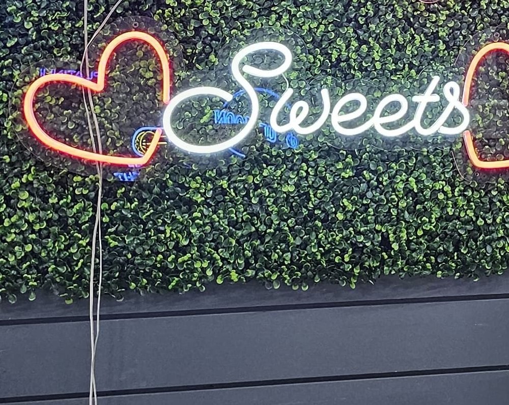 Sweets script neon sign with heart accents, for a dessert table